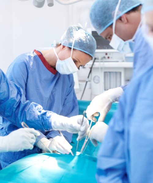 Group of surgeons working on a patient lying down on an operating table during an operation